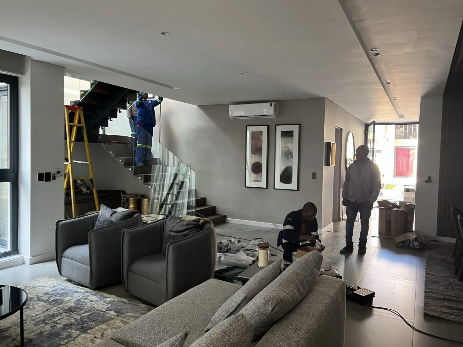 Curtain Solutions Fourways team doing an installation in a living room